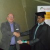 Mike Watson Presents Syed Hashmi with His Diploma